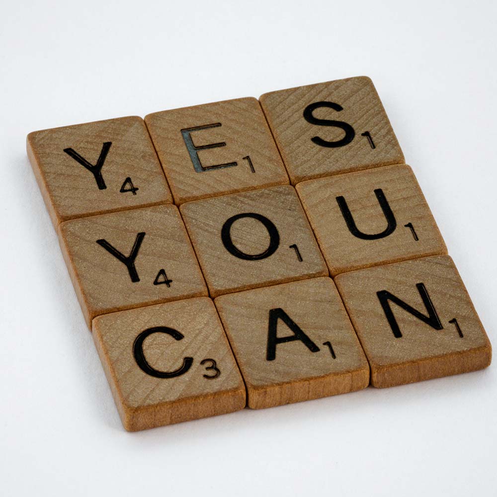Scrabble pieces that spell out Yes You Can.  